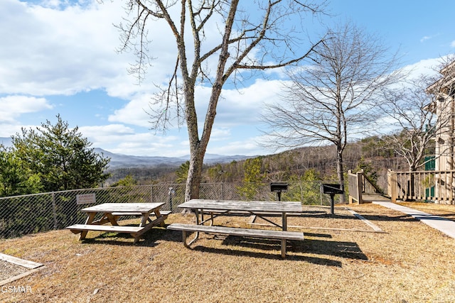 view of yard featuring fence and a mountain view