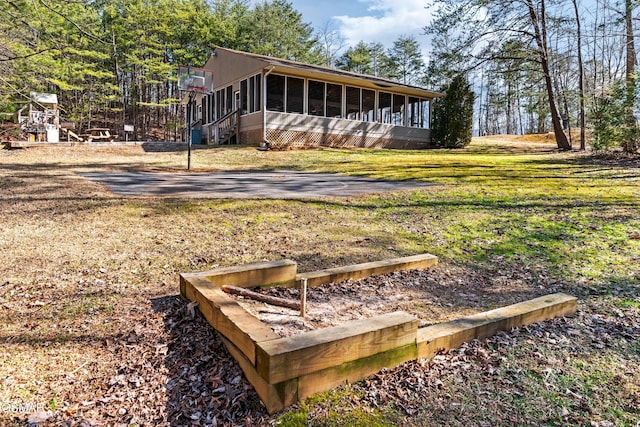 exterior space with a front yard and a sunroom