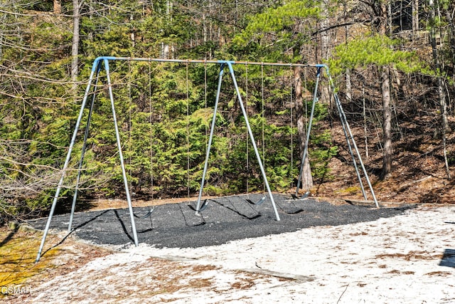 view of play area with a view of trees