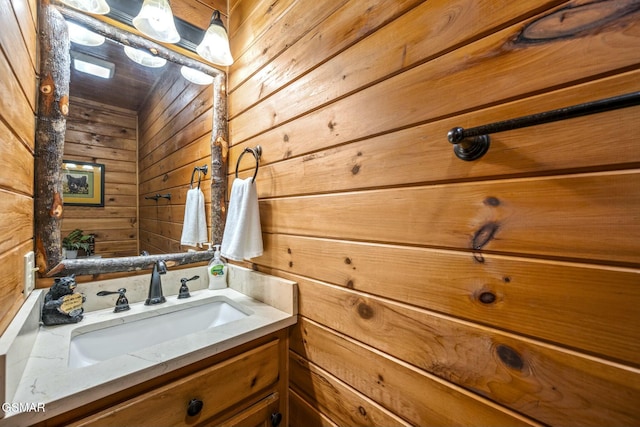 bathroom with wooden walls and vanity