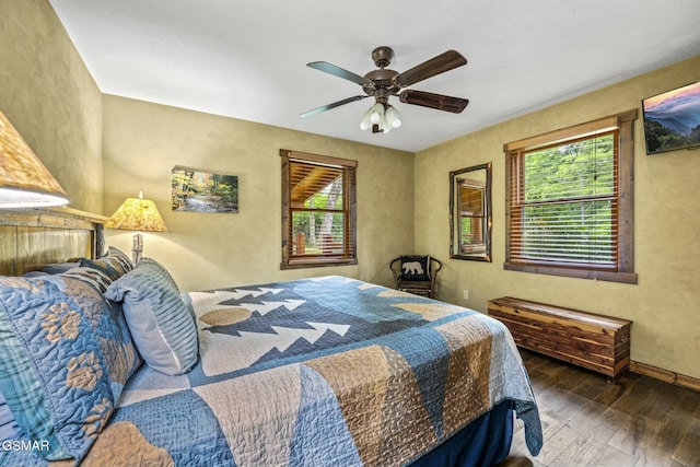 bedroom with dark wood-style flooring and a ceiling fan