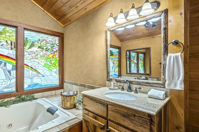 bathroom with a textured wall, lofted ceiling, wooden ceiling, a tub, and vanity