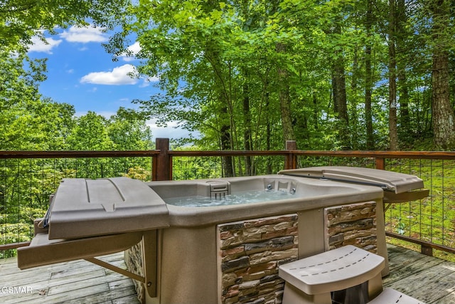 wooden terrace with a hot tub