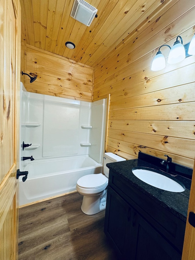 full bathroom featuring toilet, shower / bathing tub combination, wooden ceiling, wooden walls, and hardwood / wood-style flooring