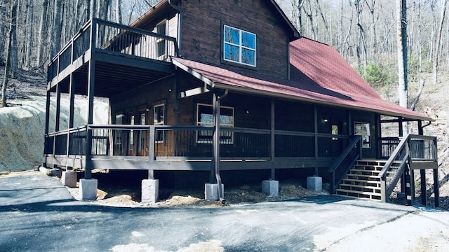 view of side of home with a wooden deck