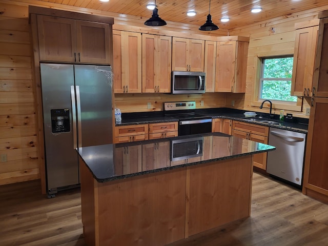 kitchen with sink, wooden ceiling, a kitchen island, pendant lighting, and stainless steel appliances