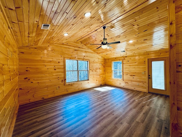 bonus room with lofted ceiling, wooden ceiling, wooden walls, dark hardwood / wood-style flooring, and ceiling fan