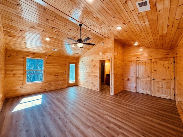 bonus room featuring wood ceiling, ceiling fan, wooden walls, wood-type flooring, and vaulted ceiling