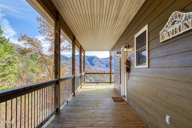 wooden deck with a mountain view