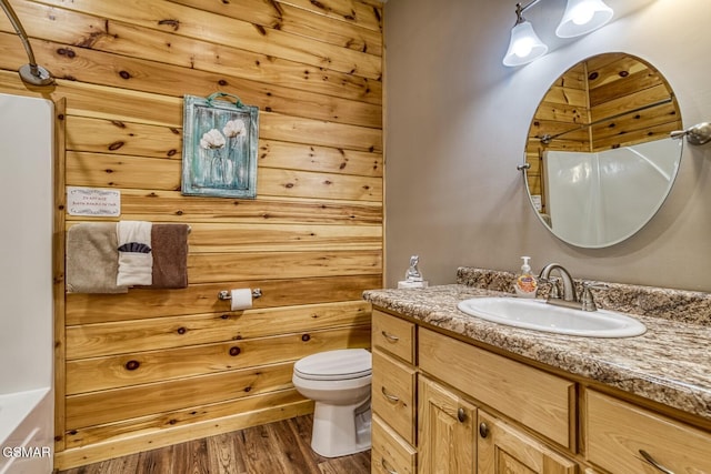 bathroom featuring wood-type flooring, vanity, and toilet