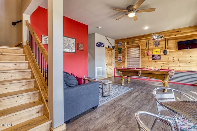 game room featuring pool table, hardwood / wood-style flooring, ceiling fan, and wood walls