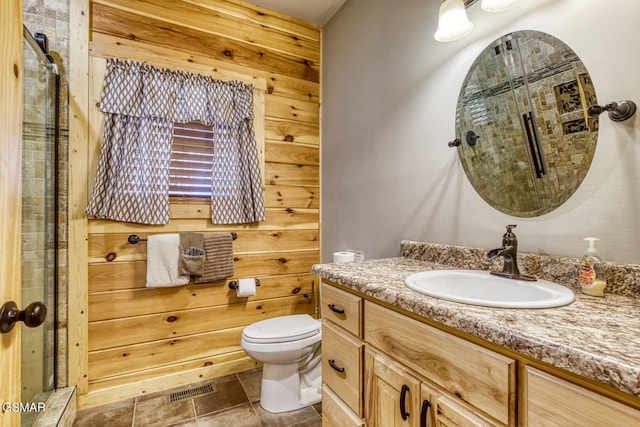 bathroom featuring wood walls, vanity, and toilet