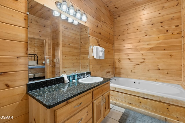 bathroom with tile patterned floors, vanity, a bathtub, and wood walls