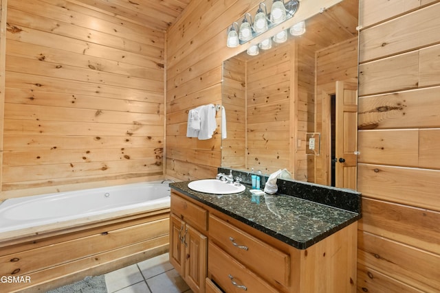 bathroom with vanity, tile patterned floors, a bathtub, and wood walls