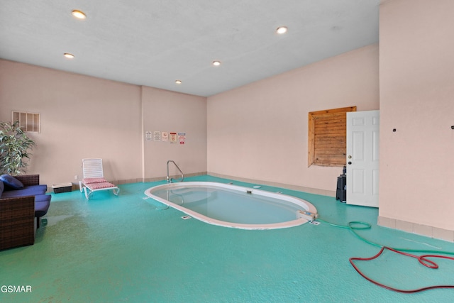 view of pool with a hot tub