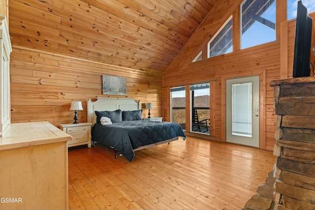 bedroom featuring high vaulted ceiling, wooden walls, access to outside, wooden ceiling, and light hardwood / wood-style flooring