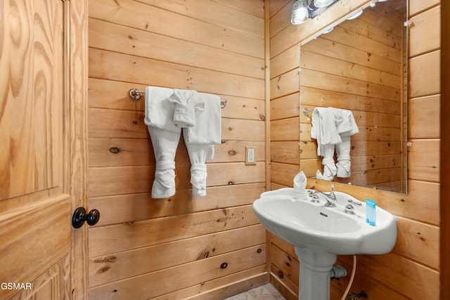 bathroom featuring wooden walls