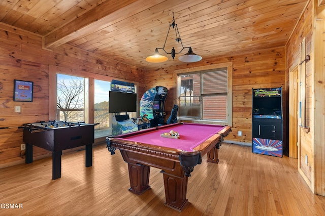 recreation room featuring beam ceiling, wood walls, wood ceiling, and light hardwood / wood-style floors