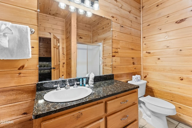 bathroom featuring vanity, an enclosed shower, toilet, and wood walls