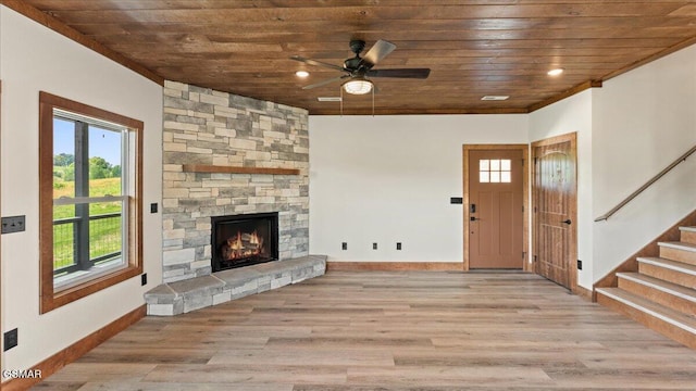 unfurnished living room with wood finished floors, a wealth of natural light, and wood ceiling