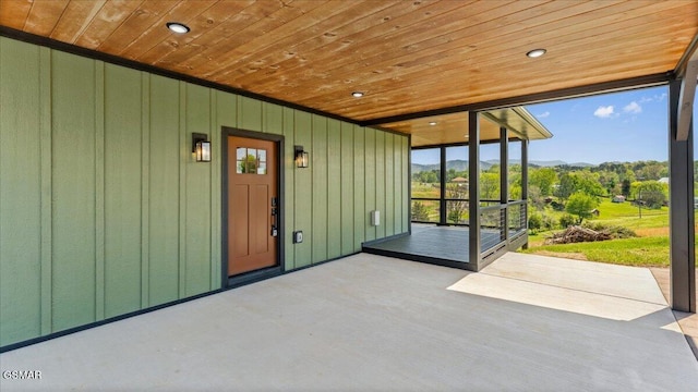 property entrance with a mountain view and board and batten siding