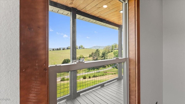 doorway to outside with a mountain view and wood ceiling