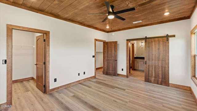 unfurnished bedroom with wood ceiling, a spacious closet, light wood-style flooring, and baseboards