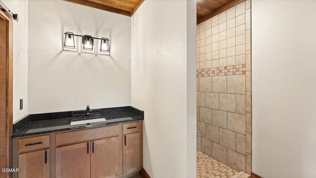 full bathroom with tiled shower, vanity, and wood ceiling