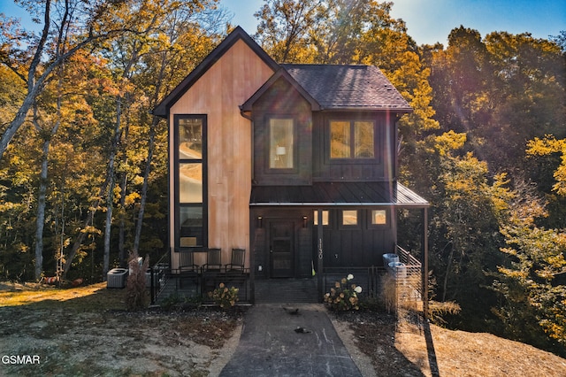 view of front facade featuring a porch and central air condition unit