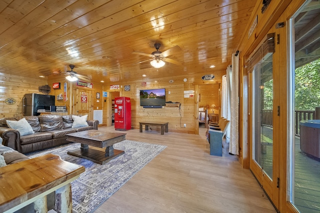 living room featuring wood ceiling, light hardwood / wood-style floors, ceiling fan, and wood walls