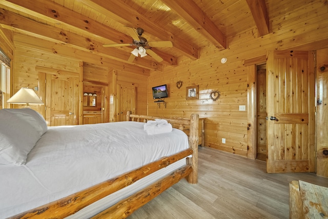 bedroom with wood walls, wood ceiling, hardwood / wood-style flooring, ceiling fan, and beam ceiling