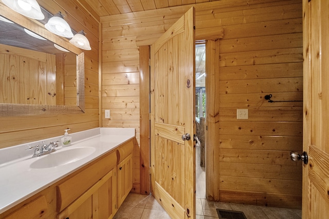 bathroom with vanity, tile patterned floors, wooden ceiling, and wood walls