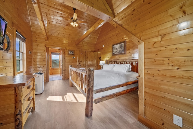 bedroom with high vaulted ceiling, wood walls, beam ceiling, wooden ceiling, and light wood-type flooring