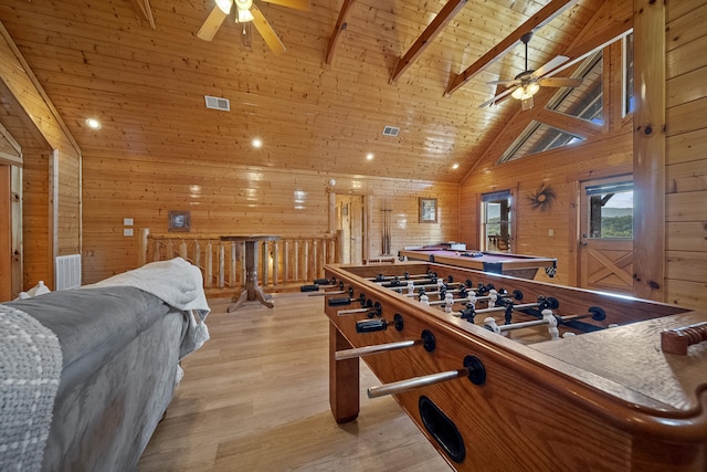 playroom featuring wooden ceiling, beam ceiling, light hardwood / wood-style flooring, and wood walls