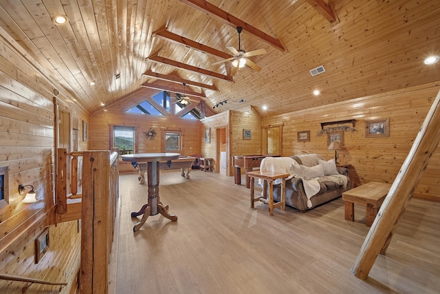 interior space with wood ceiling, wooden walls, beam ceiling, and high vaulted ceiling