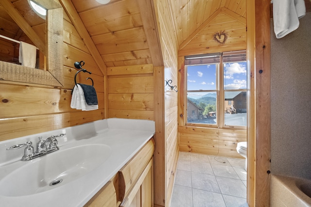 bathroom featuring tile patterned flooring, a mountain view, vaulted ceiling, wooden ceiling, and wood walls