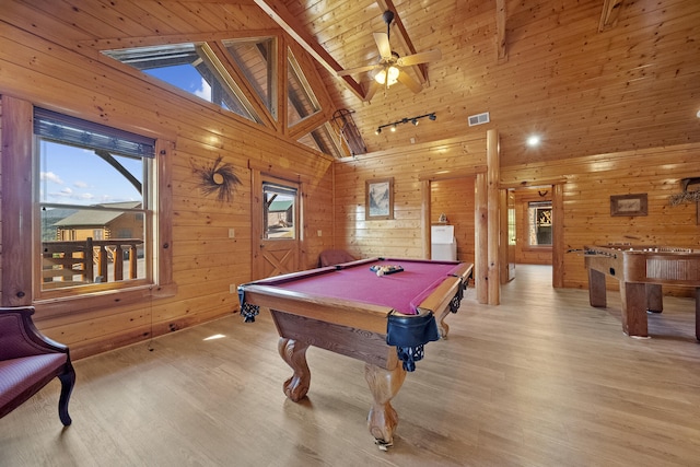 playroom featuring wood walls, wood ceiling, high vaulted ceiling, beamed ceiling, and light hardwood / wood-style floors