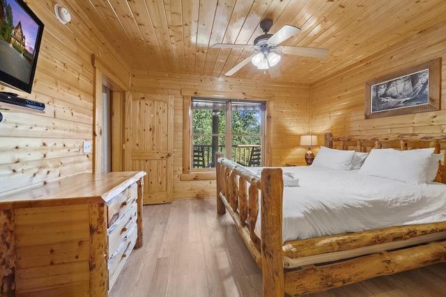 bedroom featuring wooden ceiling, wooden walls, ceiling fan, access to exterior, and light hardwood / wood-style floors