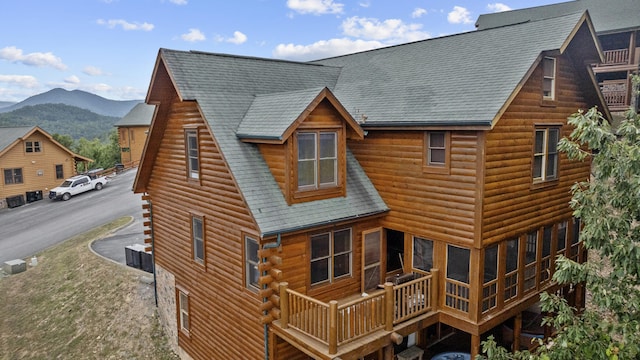 back of property featuring a mountain view