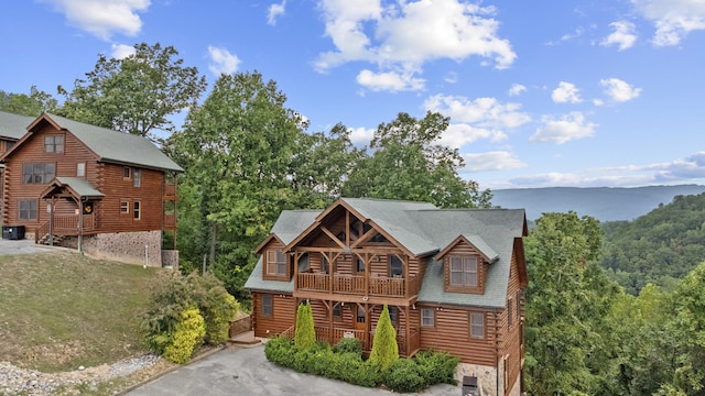 cabin with a mountain view, a balcony, central AC unit, and covered porch