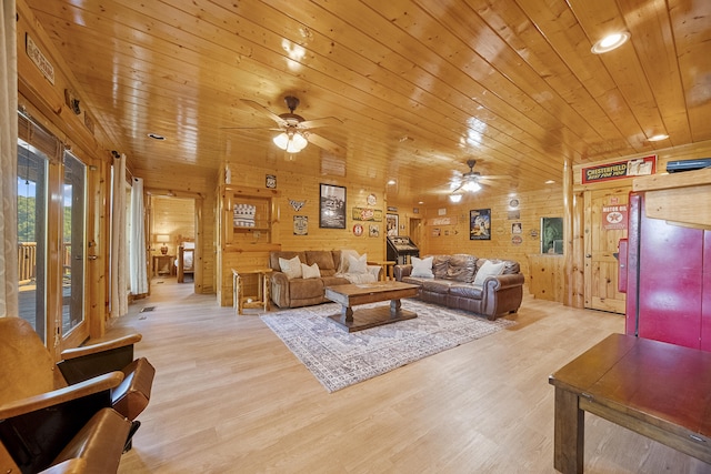 living room with light hardwood / wood-style flooring, wooden walls, and wooden ceiling