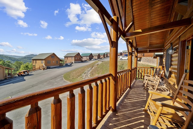 balcony featuring a mountain view and covered porch