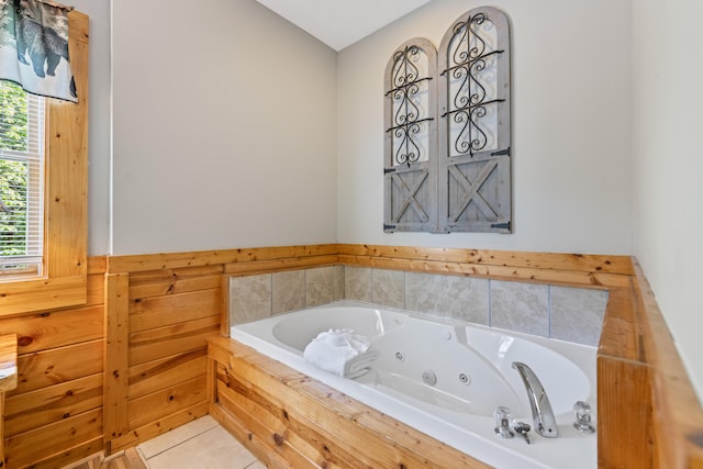 bathroom featuring tile patterned flooring and a relaxing tiled tub