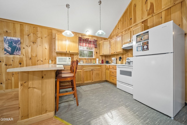 kitchen with a breakfast bar area, light brown cabinets, decorative light fixtures, and white appliances