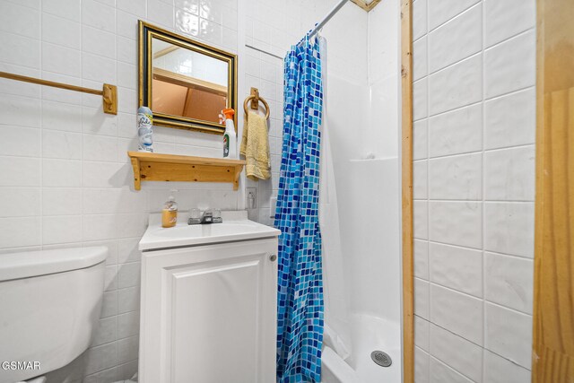 bathroom featuring vanity, toilet, and walk in shower