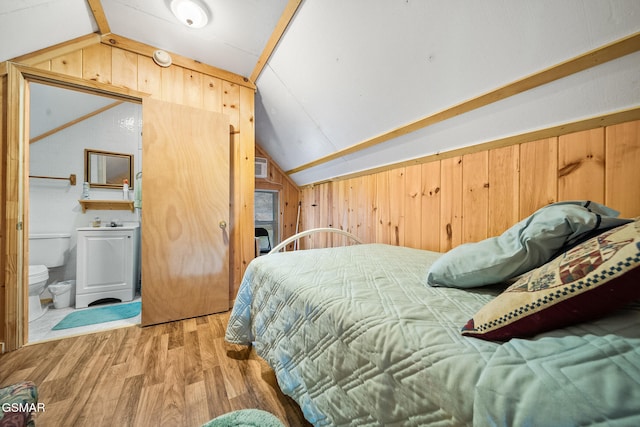 bedroom with hardwood / wood-style flooring, lofted ceiling, and wood walls