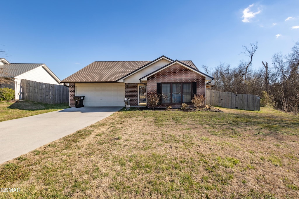 single story home featuring fence, driveway, an attached garage, a front lawn, and brick siding