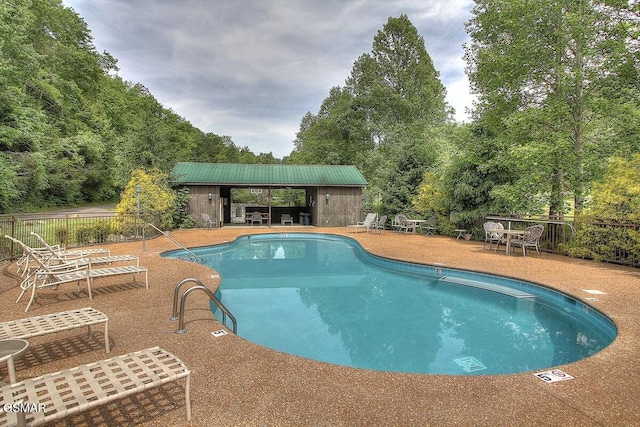 2839 Cedar Falls Way, Sevierville, TN 37862 - community pool featuring a patio area and view of wooded area