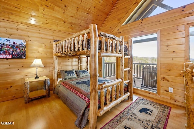 2839 Cedar Falls Way, Sevierville, TN 37862 - bedroom with lofted ceiling, access to outside, wood walls, and wood finished floors