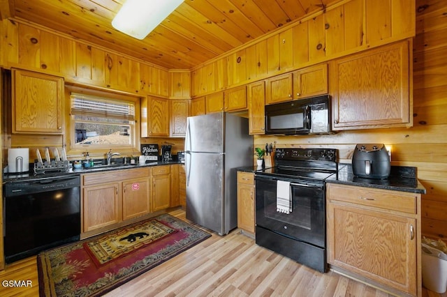 2839 Cedar Falls Way, Sevierville, TN 37862 - kitchen featuring black appliances, wooden ceiling, light wood-style floors, wood walls, and brown cabinets